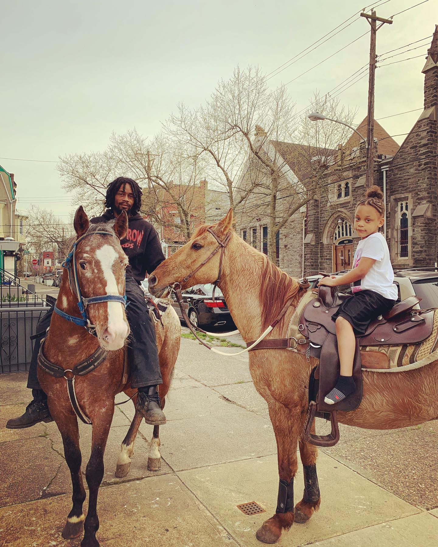 Two riders on horseback on Philadelphia street