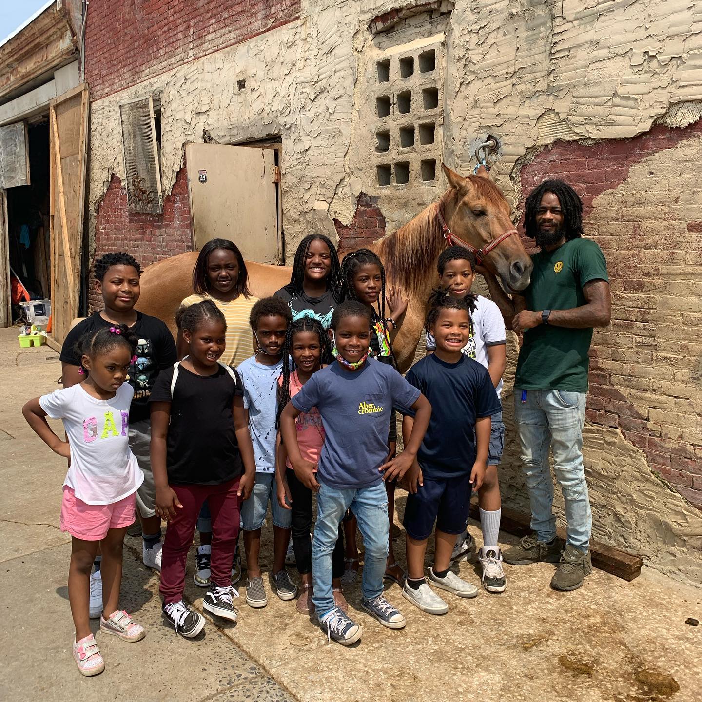Group of children and instructor with horse at Universal Skyline
